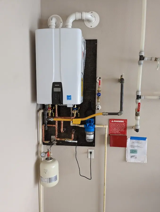 Professional plumber installing copper piping in a Woodhaven home